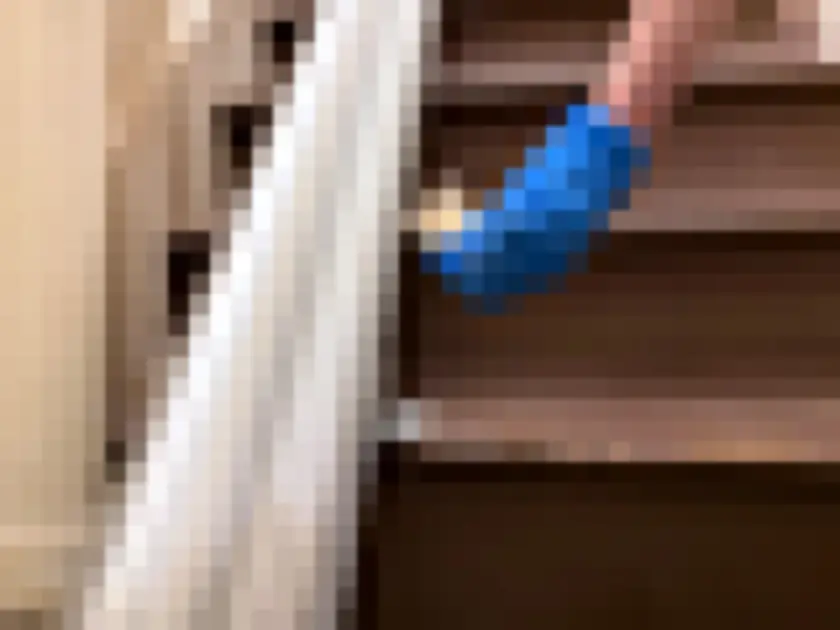 Photograph of blue-gloved hand presses small sampling media against stair tread